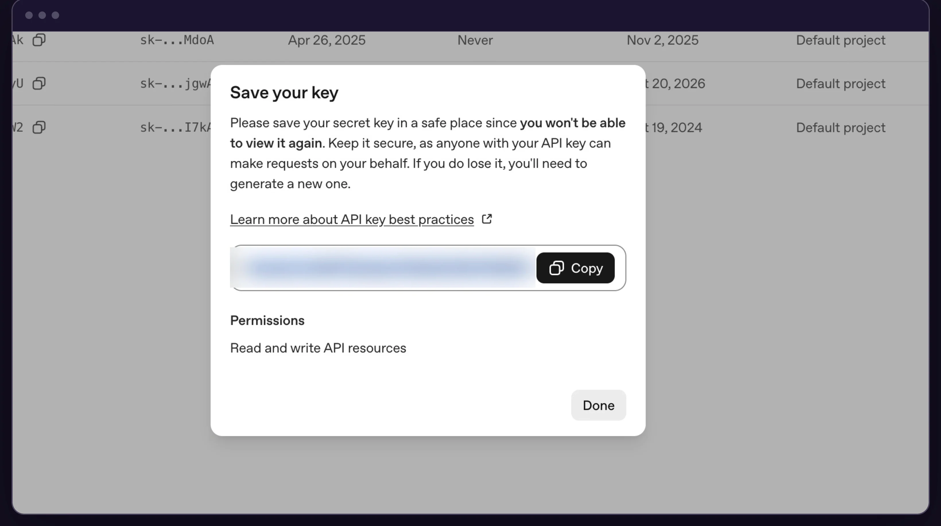 OpenAI Save your key dialog showing the new secret key once, blurred